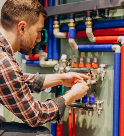 Young engineer adjusting autonomous heating Young engineer adjusting autonomous heating