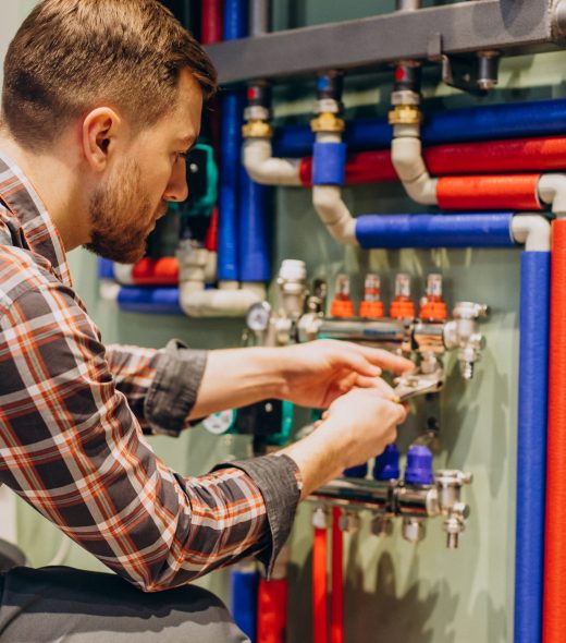 Young engineer adjusting autonomous heating Young engineer adjusting autonomous heating